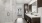 apartment bathroom with dark brown cabinets, white stone counters, and frameless walk-in shower, and a door to bedroom