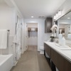 a bathroom with a tub sink and mirror