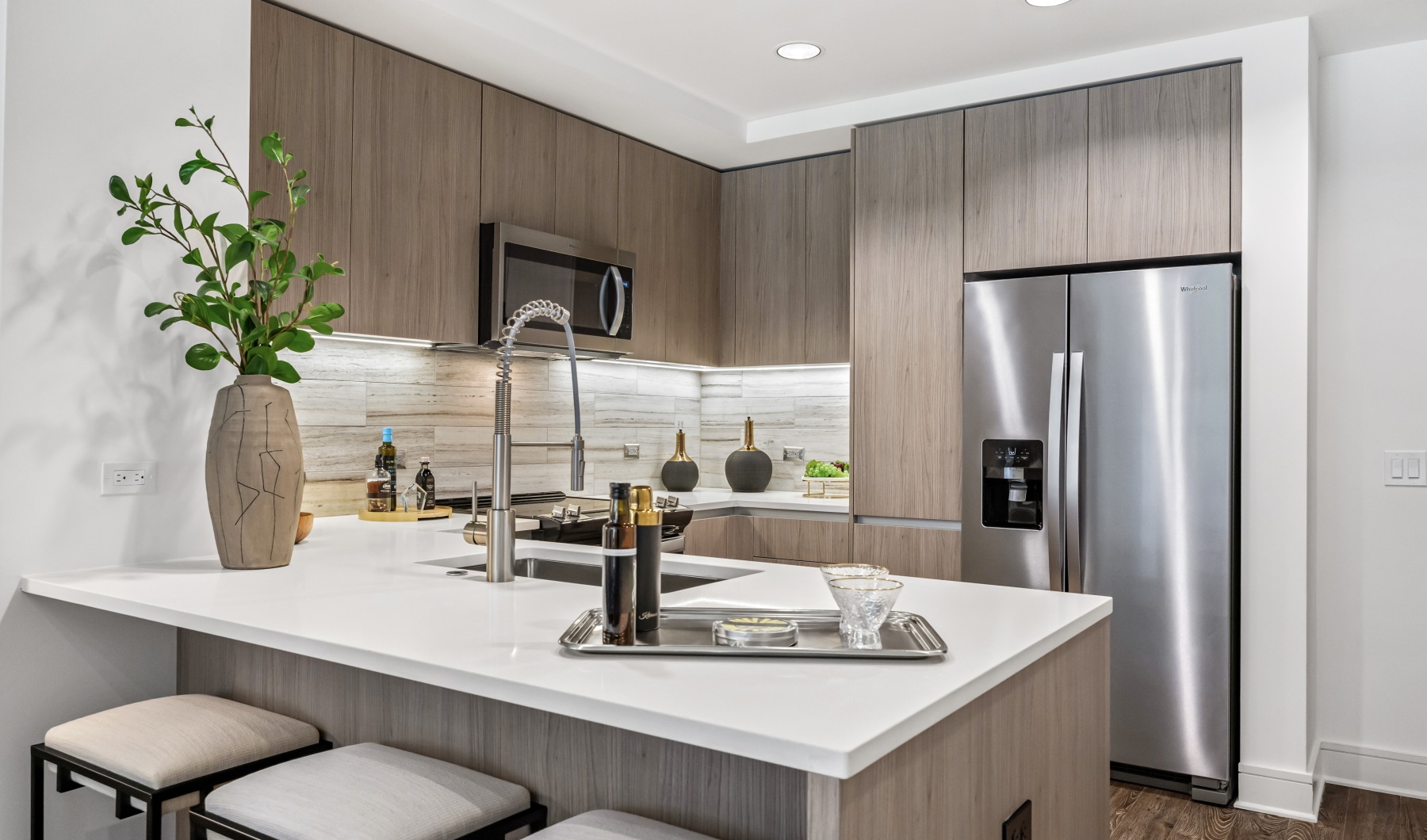 Chef-Inspired Kitchen kitchen photo with stainless steel appliances, white countertops, light nautral tone woods