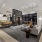 double fire place wall with tons of tables, high top seating and a couch with a chair