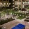 courtyard with string lights, out tvs, outdoor pool table with tons of landscaping and seating areas