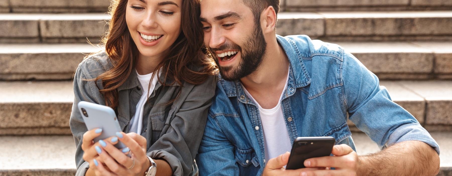 a man and a woman looking at a cell phone